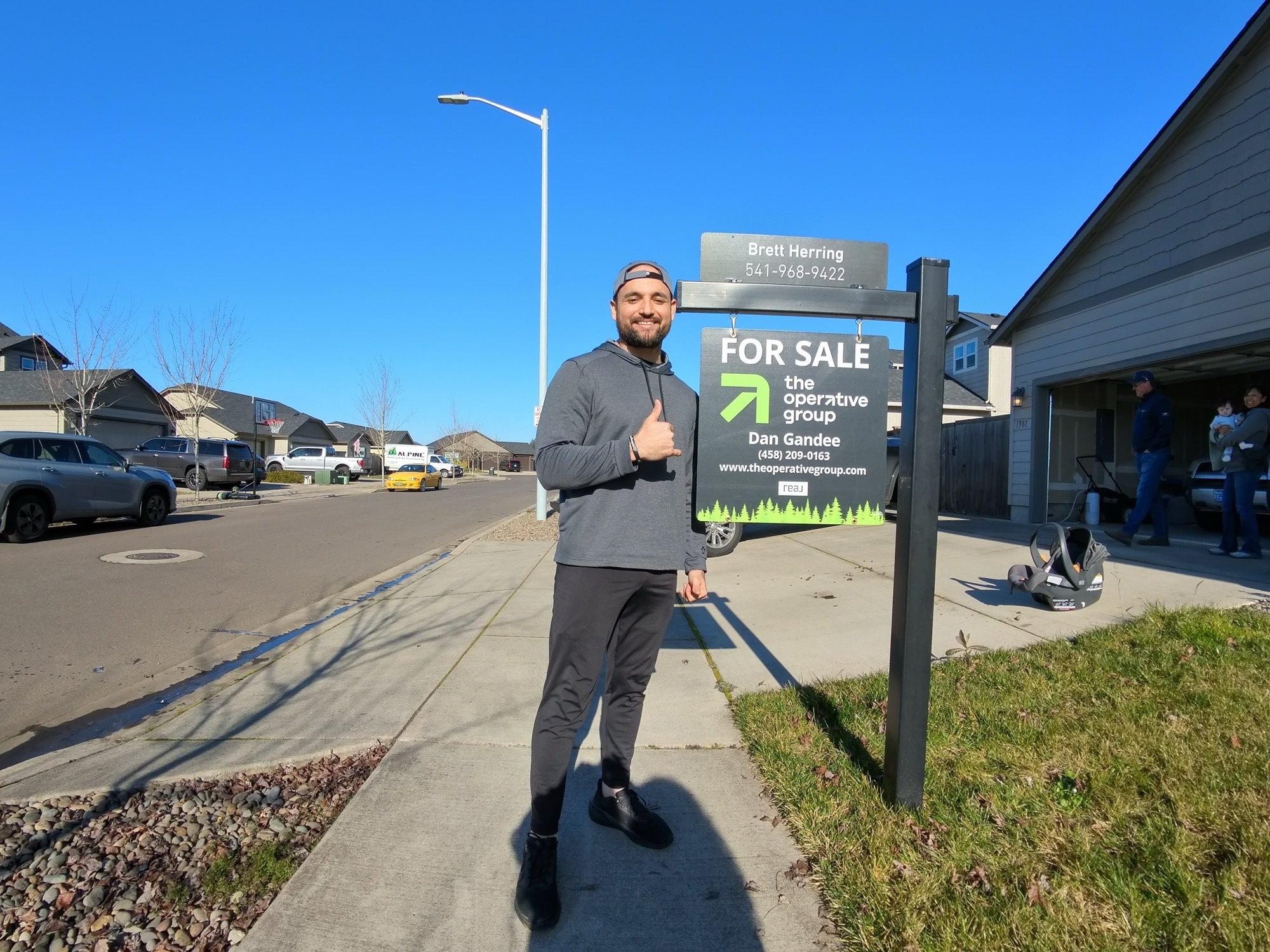 Brett Herring beside his for sale sign at a Lane County, Oregon home
